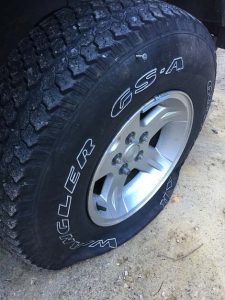 A tire with a flat tire  Description automatically generated